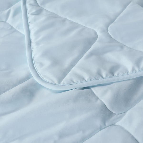 Close-up of a soft, light blue BRUKSVARA duvet, showcasing its smooth texture and fine stitching.