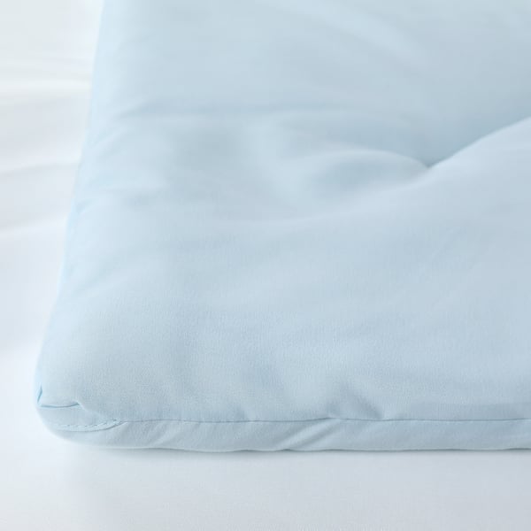 Light blue duvet on white surface, soft and fluffy, showcasing its smooth, even texture.