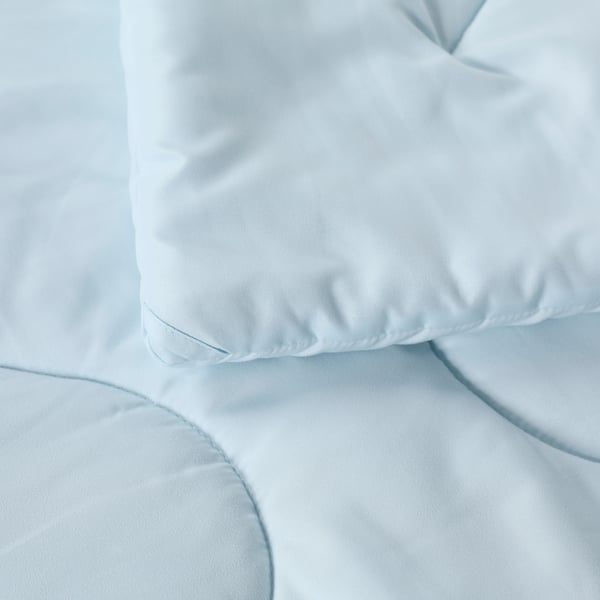 Light blue duvet, soft and fluffy; neatly placed, showcasing quality fabric.