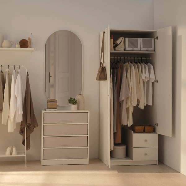 BRUKSVARA white wardrobe with drawers & hangers. Large, sleek design. Mirror & decor shelves beside. Neutral room.