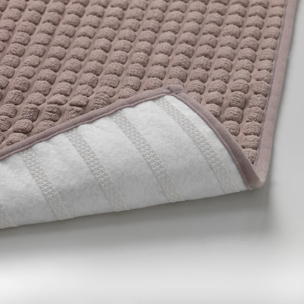 Close-up of a soft, anti-slip kitchen mat with textured surface and patterned backing.
