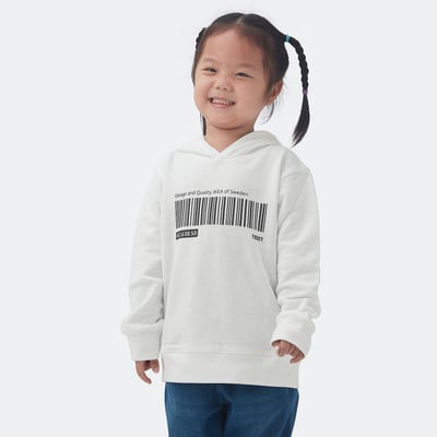 Girl wearing oversized white ikea hoodie with barcode print, part of EFTERTRÄDA collection, made from soft cotton.