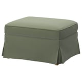 An EKTORP green footstool with a sleek, upholstered design and removable cover.