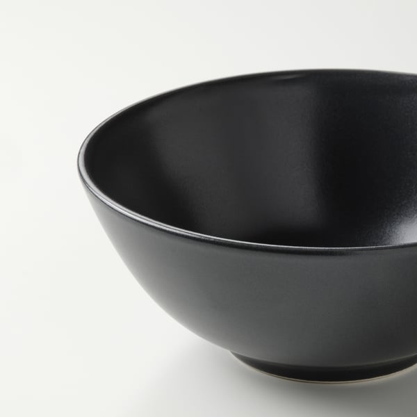 Dark bowl with smooth, glossy finish; simple design; deep and wide, perfect for various meals.