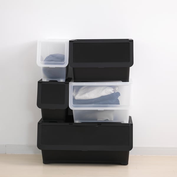 Stacked black storage bins with clear tops on wooden floor. Lids fold to access contents easily.