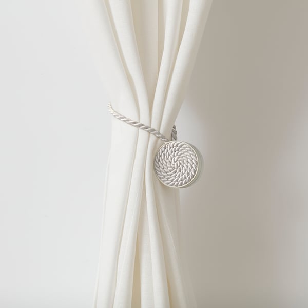 Curtain tie-back with magnetic ends, holding curtains open without drilling.