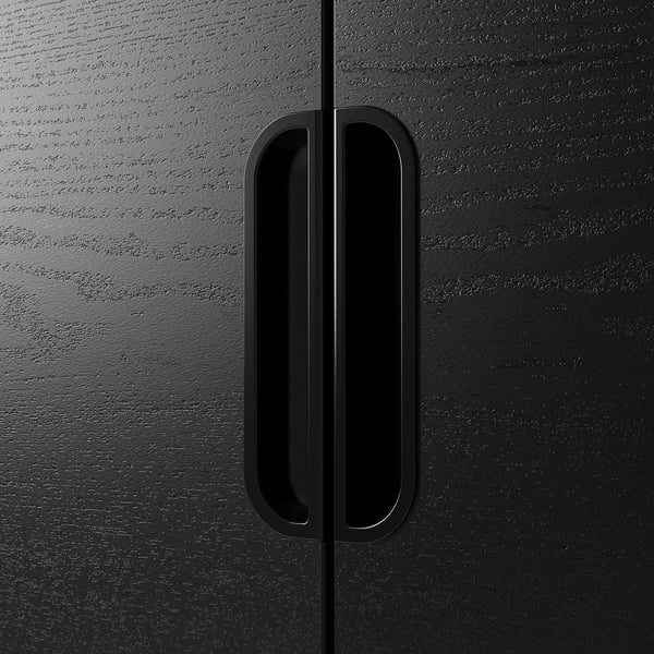 Black cabinet with sleek, vertical handle, showcasing modern design.