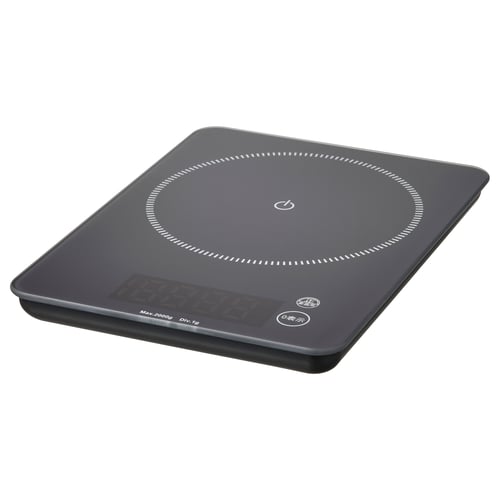Black rectangular GENOMSNITT scale with glass top, plastic base, and rubber feet. Digital display, minimalist design.