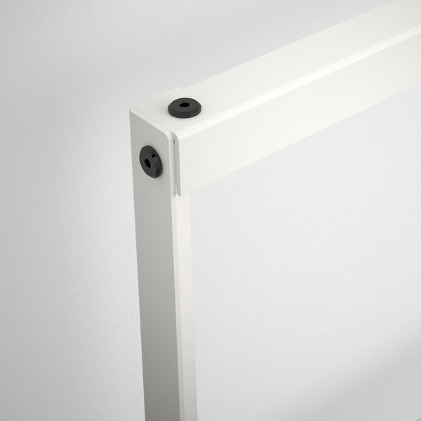 Close-up of a sturdy, white metal bed frame corner with black plastic joints, showcasing robust construction and clean design.