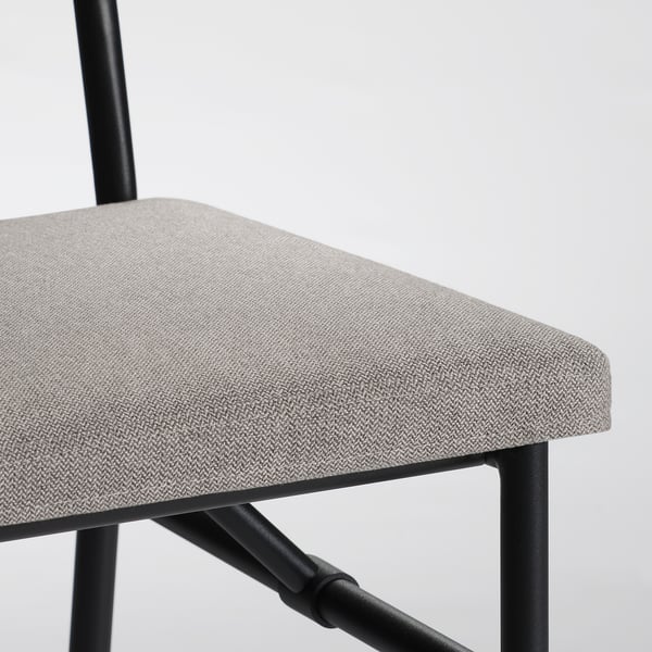 Modern chair with cushioned seat, solid pine frame, black metal legs.