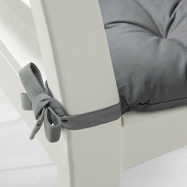 Light grey chair cushion tied neatly to slim white chair, showcasing quality fabric and design.