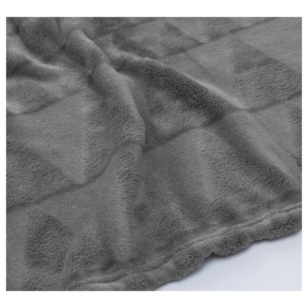 Soft, plush grey blanket close-up, showcasing its cosy, textured fabric perfect for warmth.