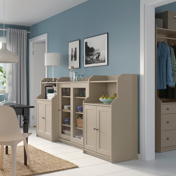 Modern living space with light wood cabinets, open & closed storage, glass doors, adjustable hinges.
