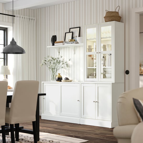 HAVSTA white sideboard with glass doors in bright room.