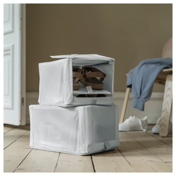 Stack of white fabric HEMMAFIXARE shoe boxes; one open shows shoes inside.