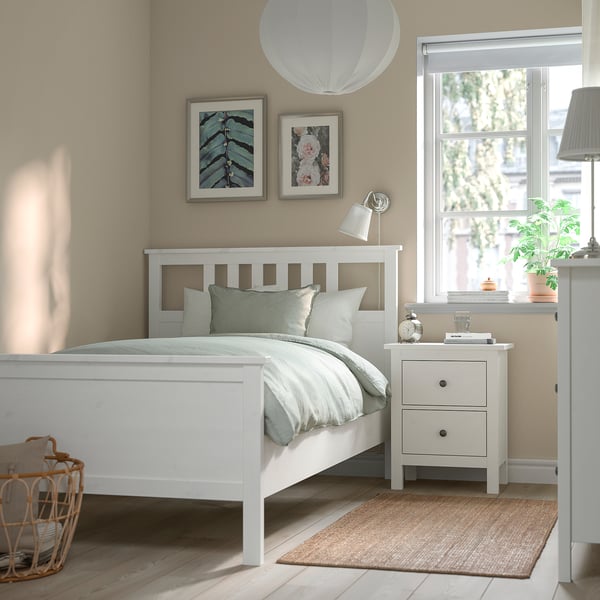 HEMNES bedroom: bed, bedside table, dresser. Bed with linens, bedside table with lamp, plant, books. Dresser with lamp, plant. Art above bed.
