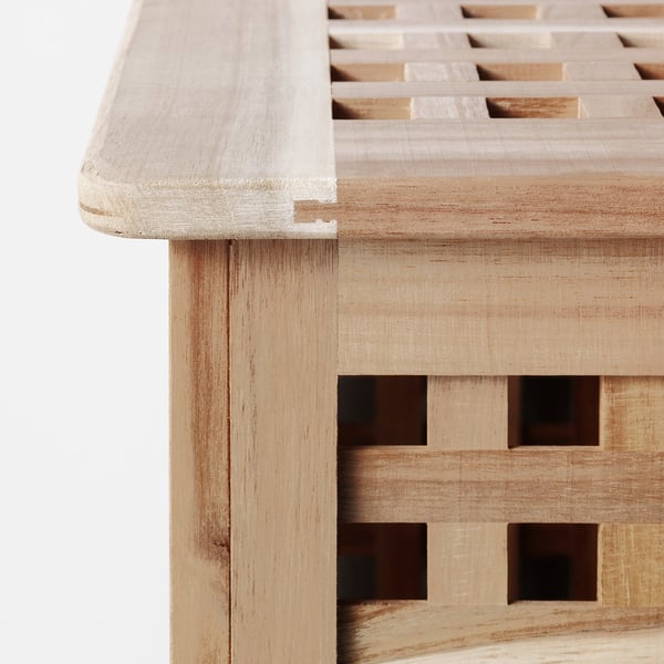 Close-up of handcrafted wooden table with intricate lattice design, smooth finish, and sturdy build.