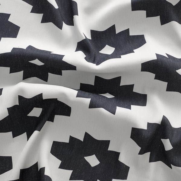 Black and white patterned curtains; thick, textured fabric; repeat leaf design; darkens room.