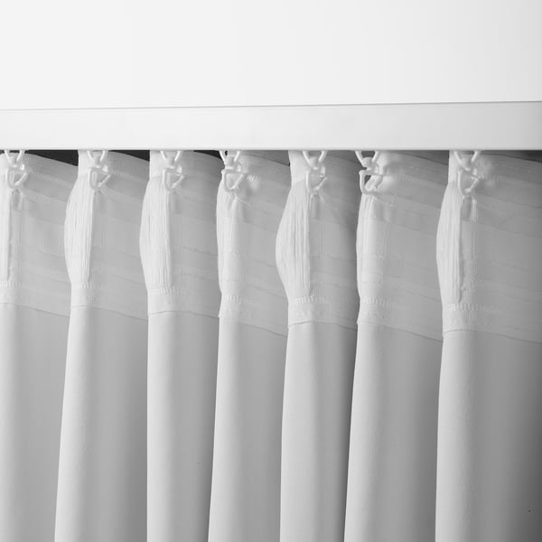 Black and white thick curtains hanging, adjustable for privacy and light control, shown with curtain hooks.