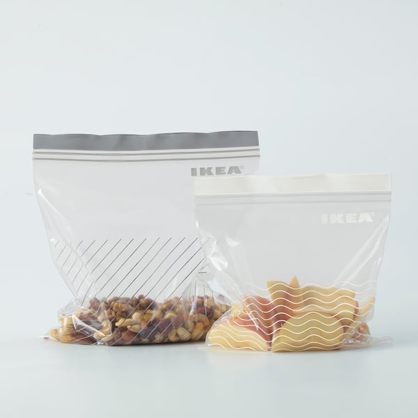 Two clear IKEA zip bags filled with snacks, one larger, one smaller, shown upright on a white surface.
