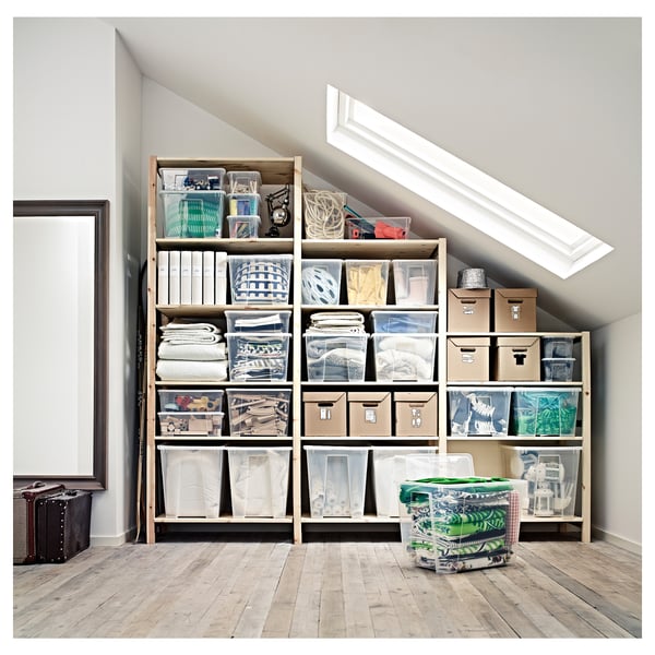 Attic storage shelves, IVAR in natural pine. Boxes store various items, neat and organised. Large skylight above, wooden floor below.