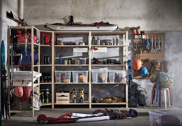 Shelves with sports gear, camping equipment, and tools.
