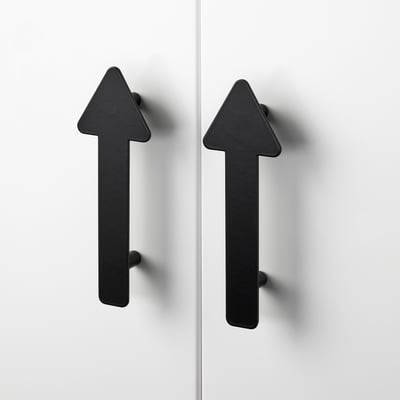 Two black triangular handles mounted on a white surface, showcasing sleek design and high-quality finish.