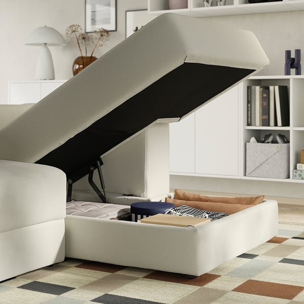 Modern sofa with lift-up bed and cushion storage.