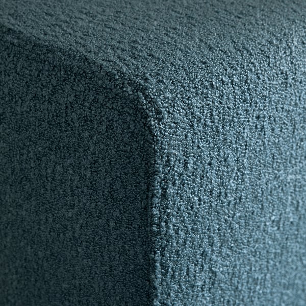 Close-up of soft, textured blue-gray fabric, likely a sofa cover, showcasing high-quality, inviting texture.