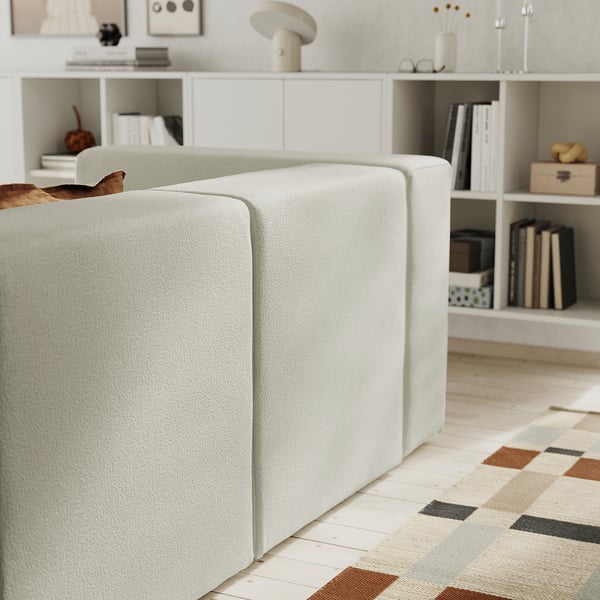 Modern living room with JÄTTEBO sofa, bookshelf, and rug. Or, even shorter: modern living room with sofa and bookshelf.