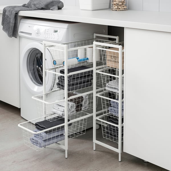 White JONAXEL steel storage next to washer, holding laundry neatly.