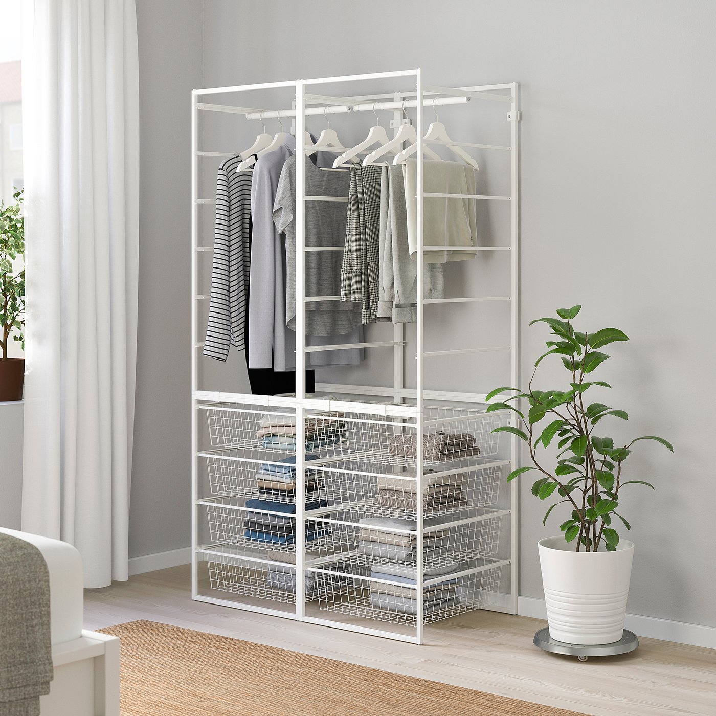 White JONAXEL storage with clothes and shelves, fits corner of bright room.