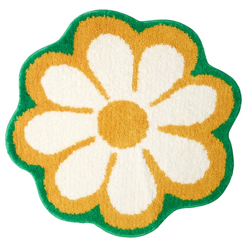 Flower-shaped bath mat, yellow and white with green border. Soft, recycled polyester and polypropylene.