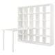 White KALLAX shelving unit with empty compartments and attached tabletop.