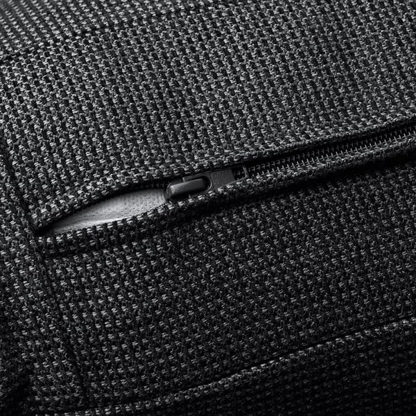Close-up of high-quality zip on textured, dark fabric, showcasing durability and craftsmanship.