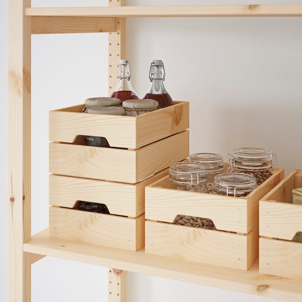 Wooden storage crates stacked on a shelf, holding bottles and jars, showcasing their sturdy and organised function.
