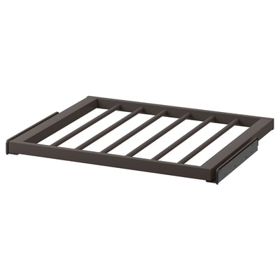 A dark grey KOMPLEMENT trouser hanger, designed with diagonal slats on a steel frame. It a smooth, epoxy powder-coated finish.
