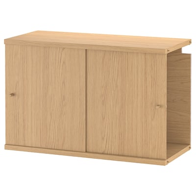 A wooden cabinet named LÅDMAKARE with sliding doors, made of fibreboard and particleboard, featuring a light brown finish.