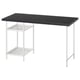 A LAGKAPTEN desk with a dark top and white metal legs, featuring open shelves.