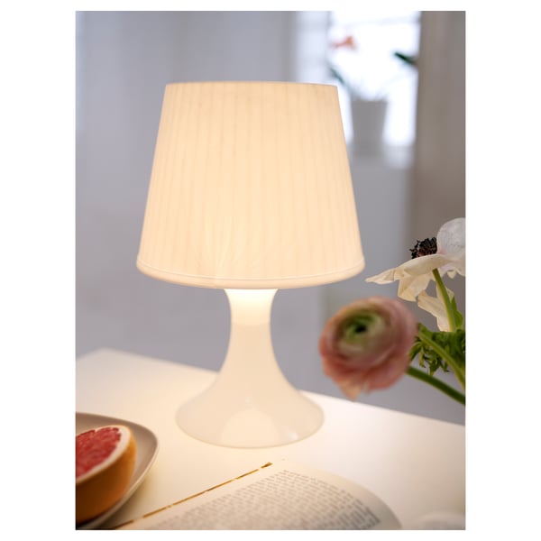 Small table lamp, grapes, book - cosy ambiance.