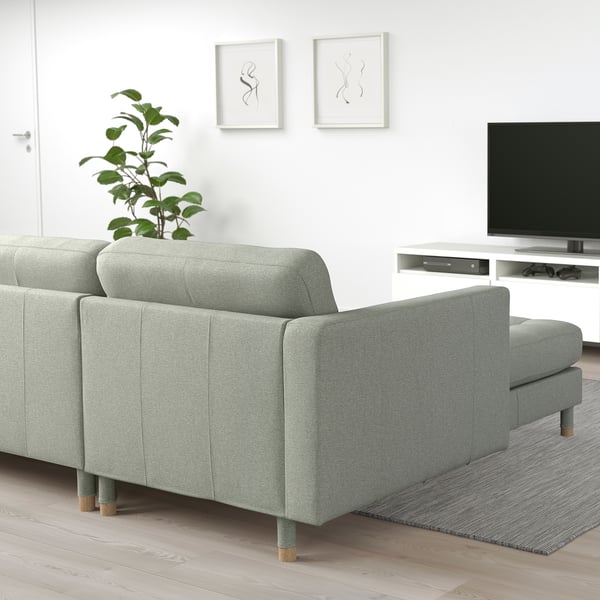 Modern living room with grey LANDSKRONA sofa, plant, tv, and abstract art.