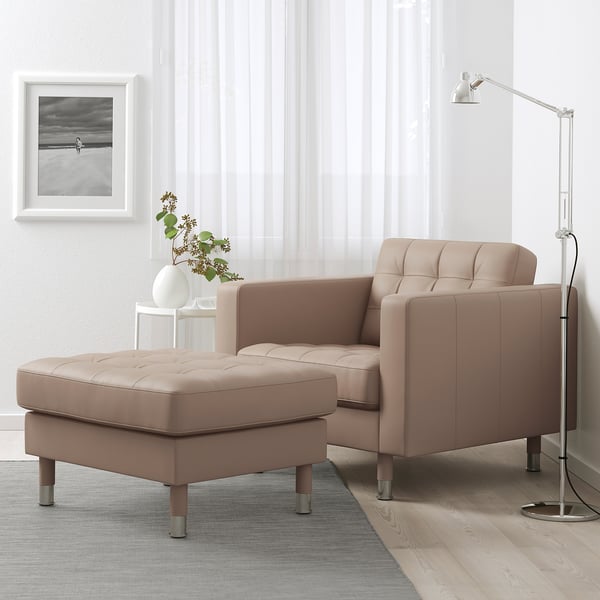 Beige LANDSKRONA chair, footstool, & floor lamp. Modern, minimalist design.