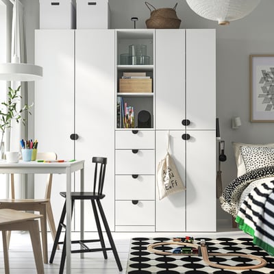Modern kids room with LASTARE storage, books, toys, & rug.