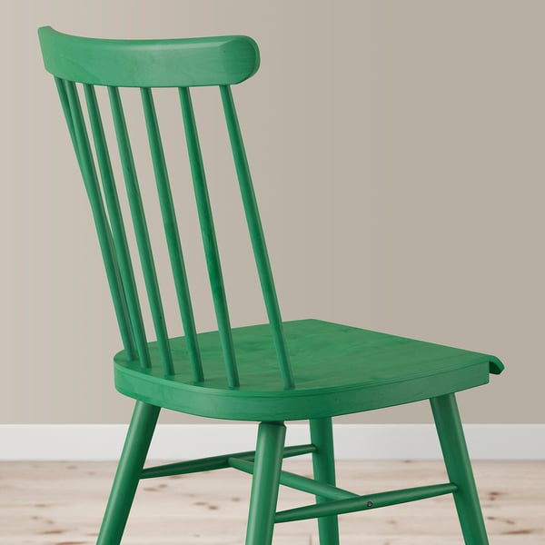 Green wooden chair with curved back & seat, durable & elegant, fits homes & public spaces.