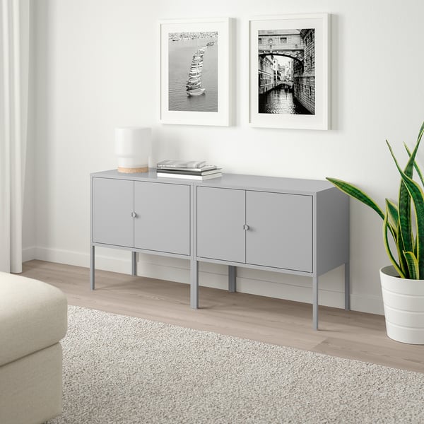 Light grey LIXHULT sideboard with metal legs. Holds books and decor. Smaller than wall frames.