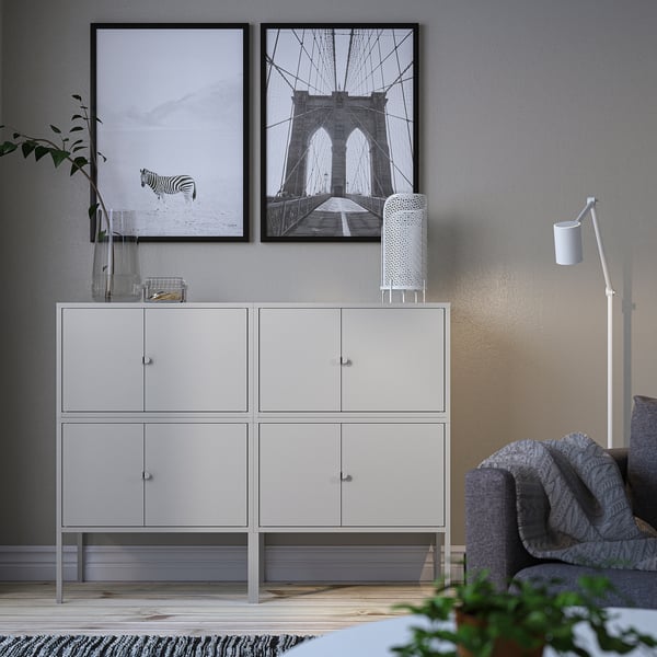 Modern living space with white LIXHULT cabinet, zebra & brooklyn bridge art.