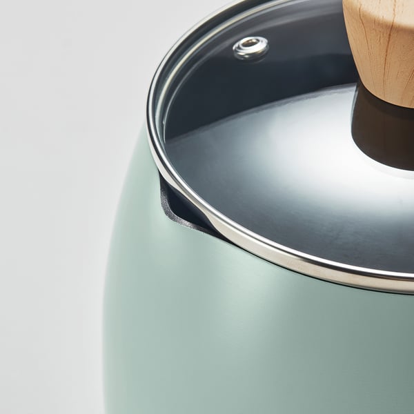 Close-up of a non-stick saucepan with a lid and wooden handle, showcasing its quality finish and materials.