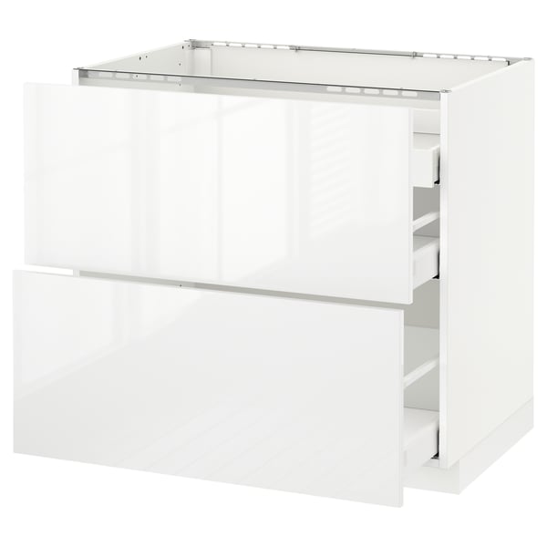 A white METOD kitchen cabinet with two drawers and a glossy finish.