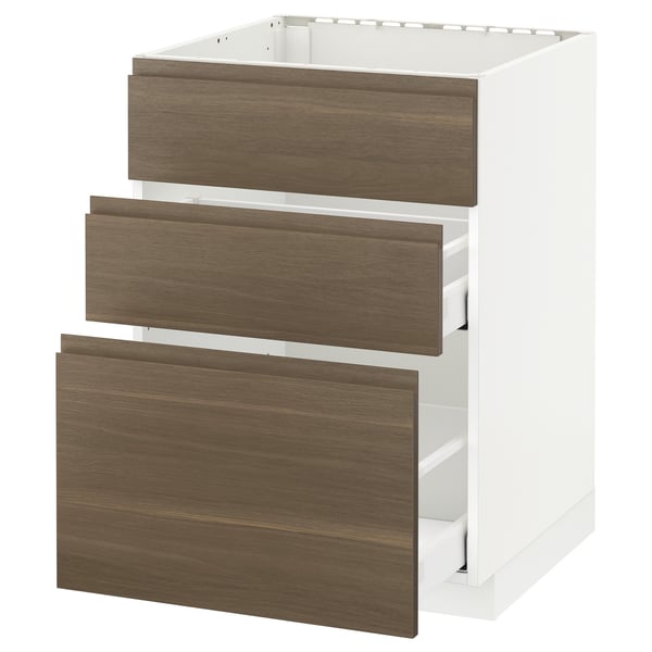 White kitchen cabinet with three dark walnut drawers.