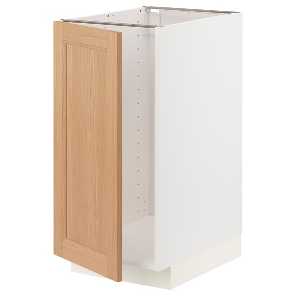 White METOD kitchen cabinet with light oak door, featuring sturdy frame and snap-on hinges.